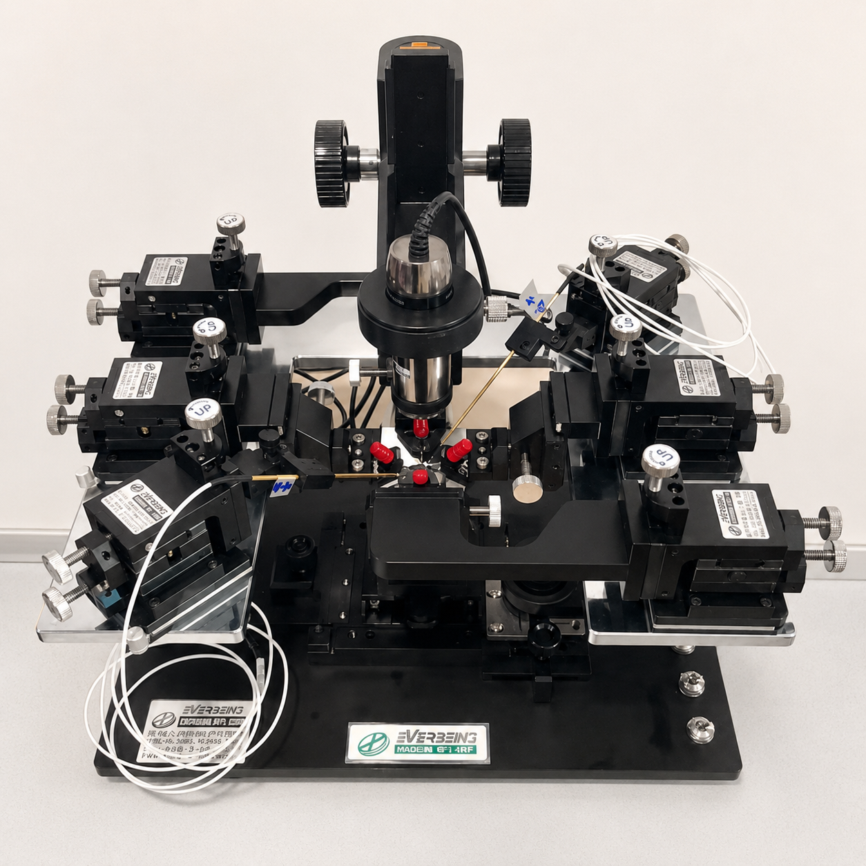 Front view of the Everbeing C-2-RF Mini Station, a compact RF-configurable analytical probe station with microscope and multiple micropositioners, shown on a light gray laboratory surface.